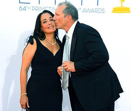 Ed O'Neill kissing in cheeks of his wife.